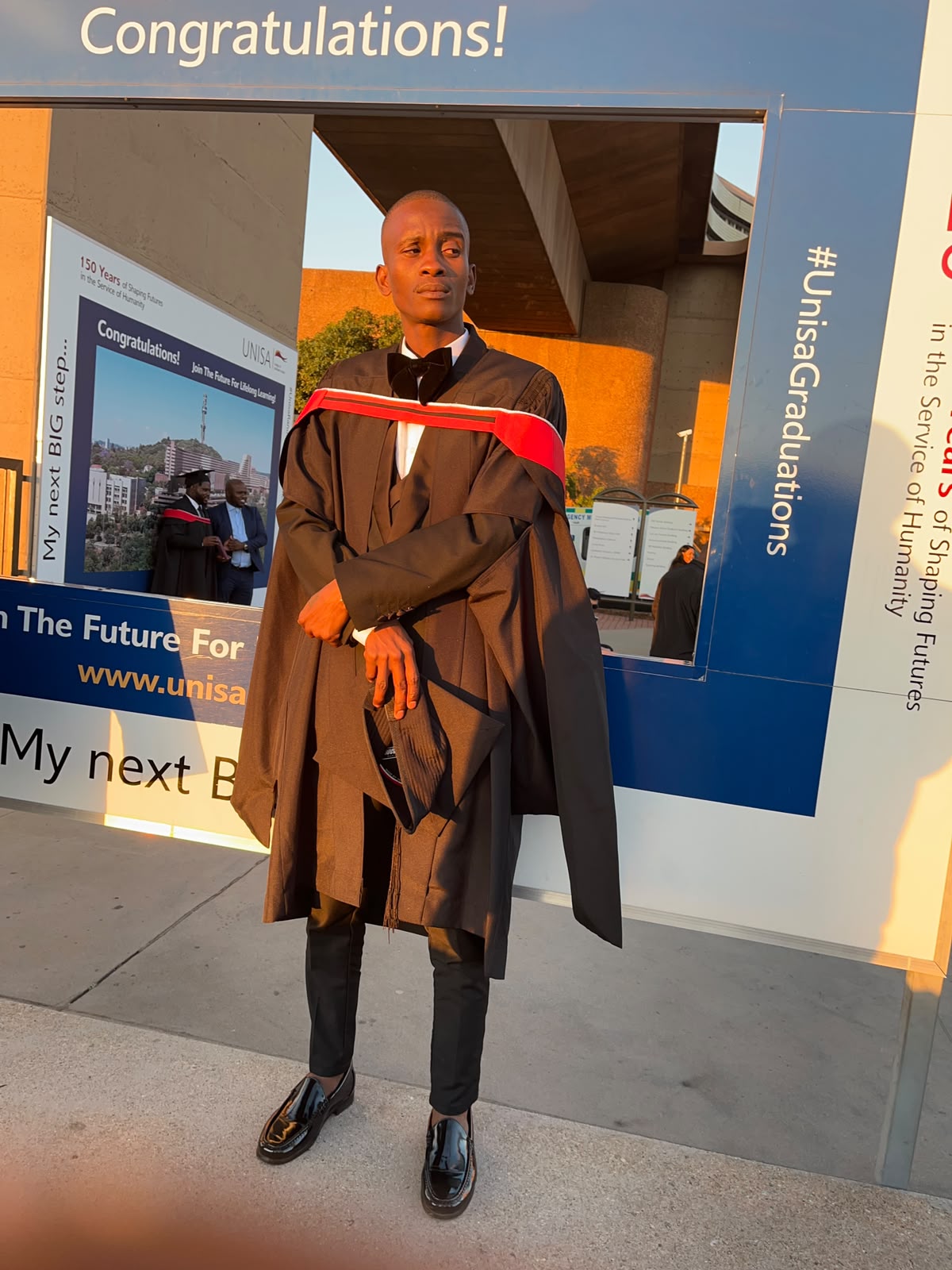 Nkadimeng Danny on graduation day at the University of South Africa, wearing the UNISA LLB gown